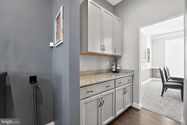 a living room with furniture and a lamp