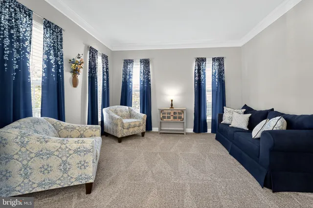 a bed room with furniture and a flat screen tv