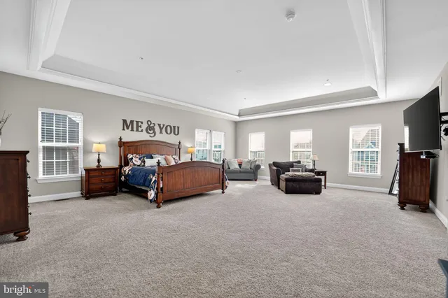 a spacious bathroom with a tub sink shower and mirror