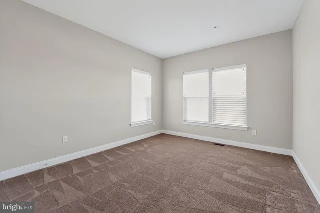 an aerial view of a house with a swimming pool patio and lake view