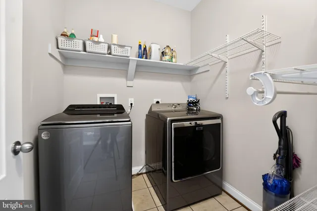 a living room with large windows and furniture