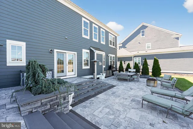 a view of a house with backyard sitting area and garden