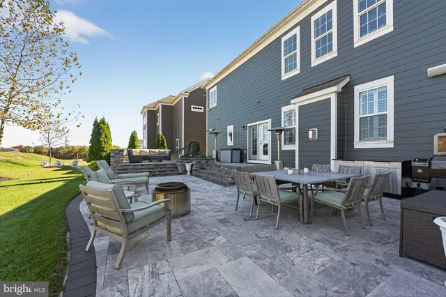 a view of a patio with couches and potted plants