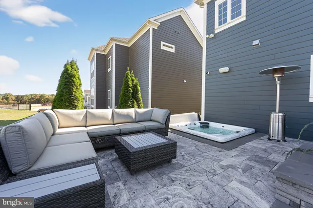 a view of a house with a big yard potted plants and large tree