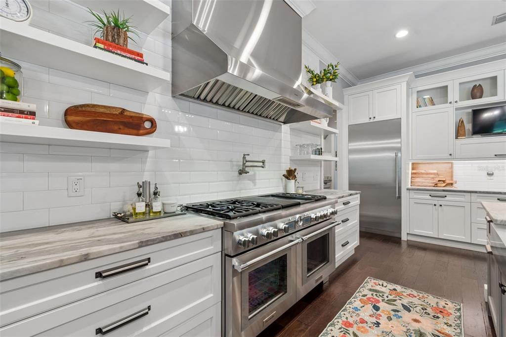 17001 Midas Lane Lutz, FL 33549 - Photo 22 of 100 a kitchen with stainless steel appliances granite countertop a stove a sink and a refrigerator