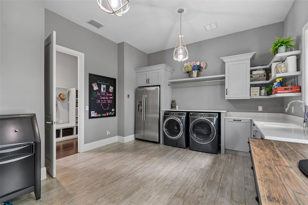 17001 Midas Lane Lutz, FL 33549 - Photo 32 of 100 a view of a kitchen with fridge and wooden floor