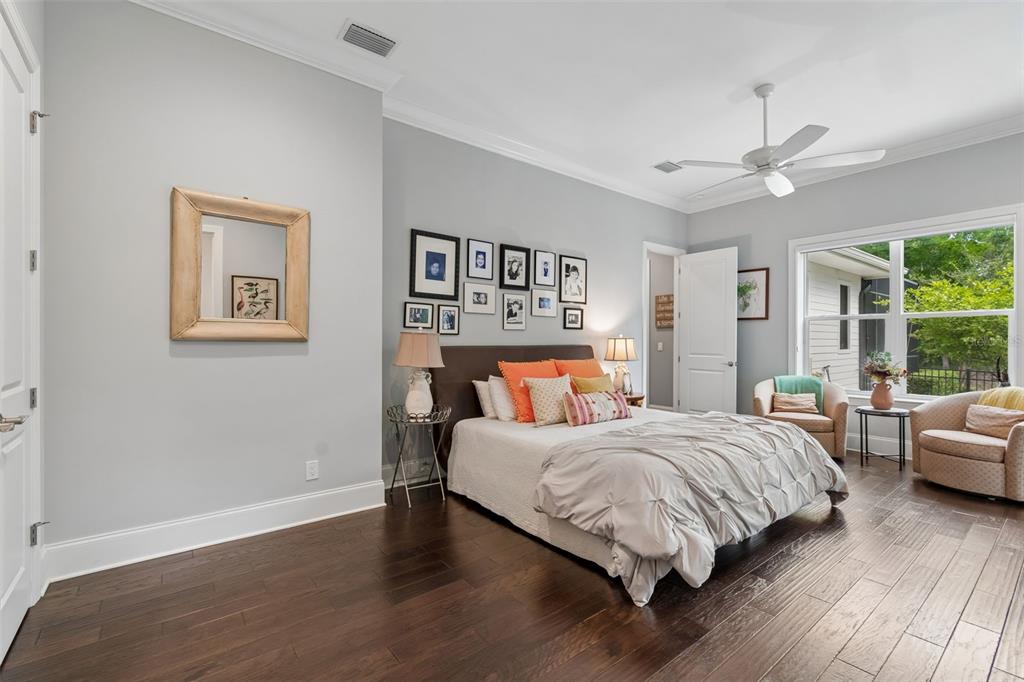 17001 Midas Lane Lutz, FL 33549 - Photo 42 of 100 a bedroom with a large bed and a chandelier