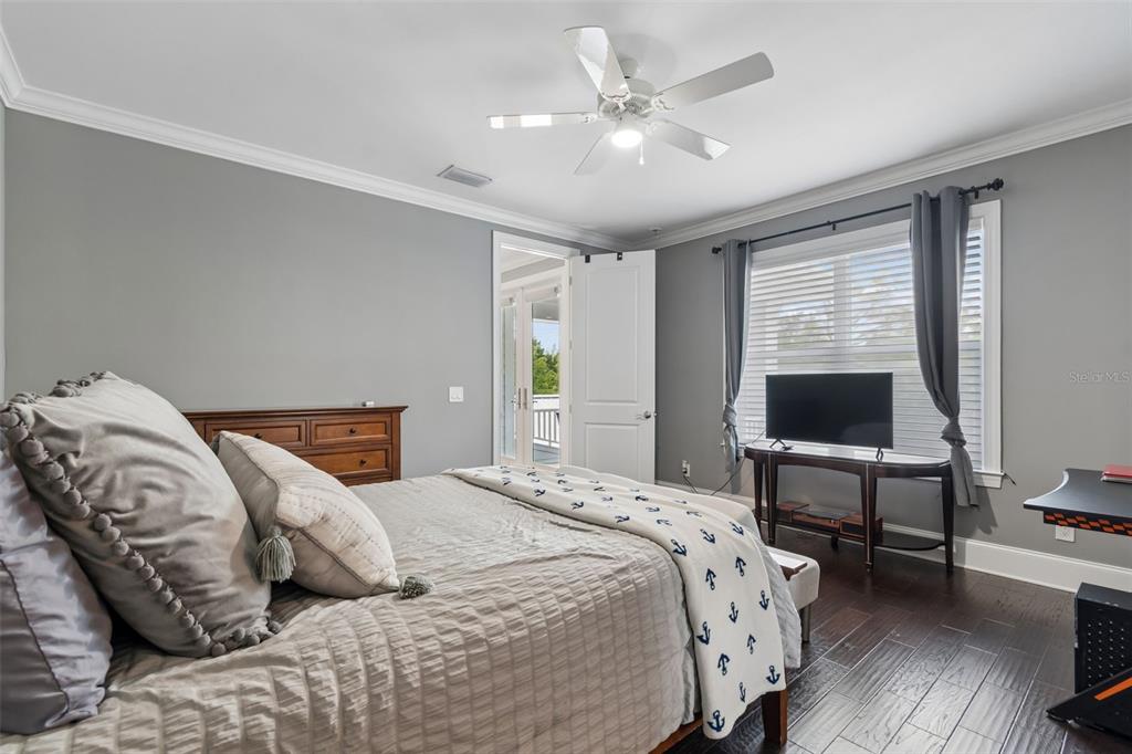 17001 Midas Lane Lutz, FL 33549 - Photo 56 of 100 a bedroom with a large bed and a chandelier