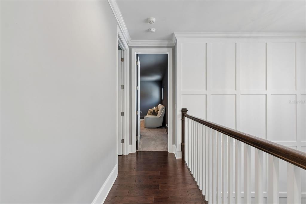 17001 Midas Lane Lutz, FL 33549 - Photo 62 of 100 a view of a hallway with wooden floor and a bathroom