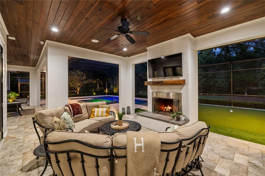 17001 Midas Lane Lutz, FL 33549 - Photo 73 of 100 a living room with furniture a fireplace and a flat screen tv