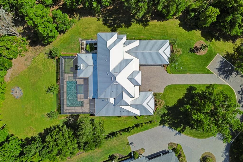 17001 Midas Lane Lutz, FL 33549 - Photo 96 of 100 an aerial view of a house with a garden and swimming pool