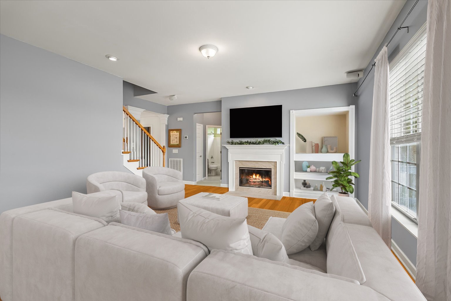 4055 Williford Way Spring Hill, TN 37174 - Photo 11 of 37 a living room with furniture a fireplace and a flat screen tv