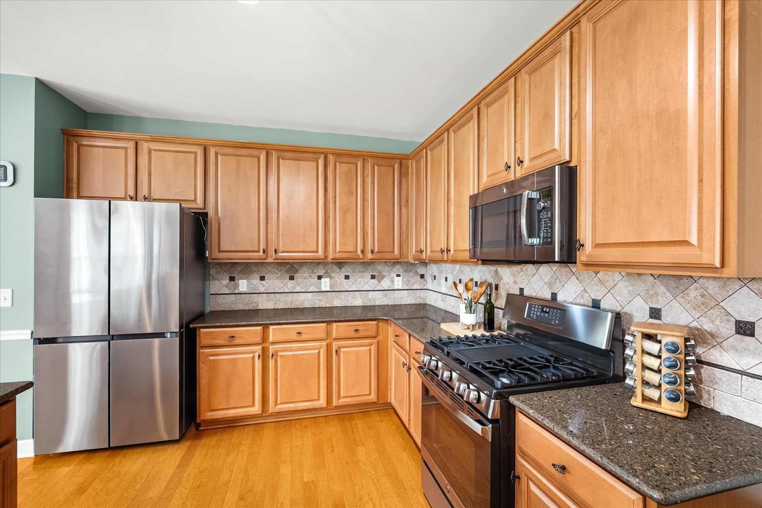 4055 Williford Way Spring Hill, TN 37174 - Photo 8 of 37 a kitchen with stainless steel appliances granite countertop a stove a sink dishwasher and a refrigerator