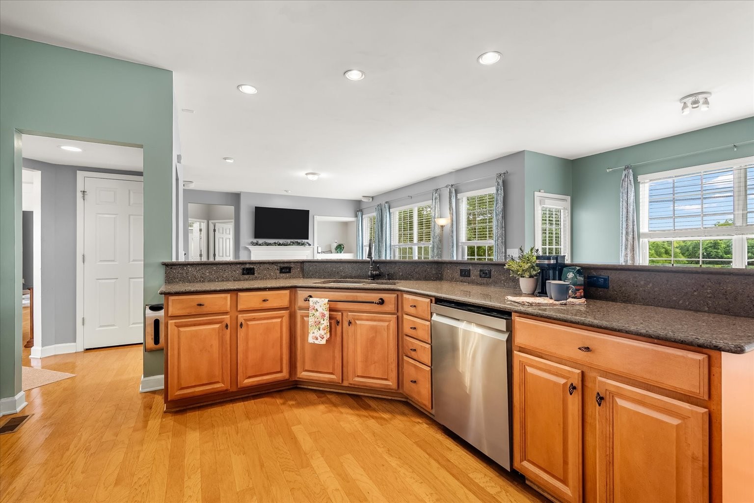 4055 Williford Way Spring Hill, TN 37174 - Photo 9 of 37 a large kitchen with stainless steel appliances granite countertop a sink and dishwasher with wooden floor