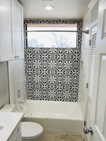 a bathroom with a bathtub and shower