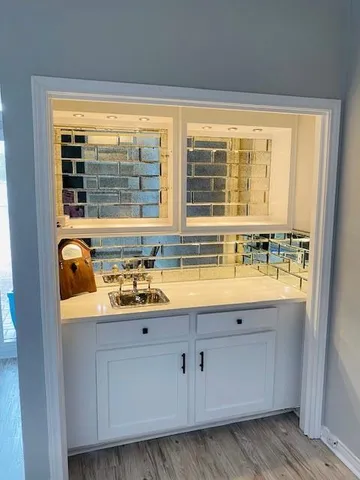 a view of bathroom with granite countertop a sink and a window
