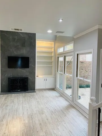 a view of a livingroom with an empty space and a fireplace
