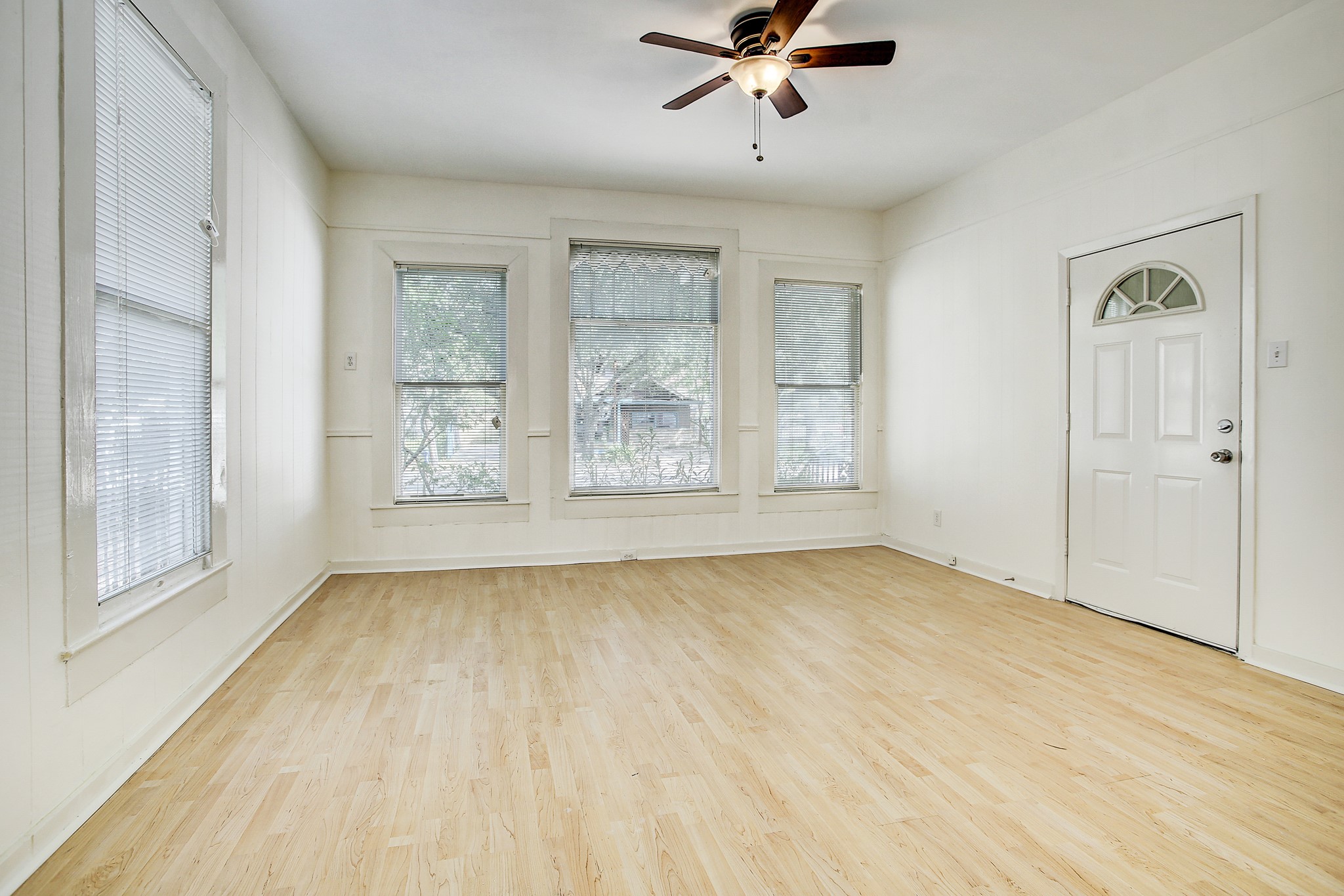 1127 Yale Street, Unit B Houston, TX 77008 - Photo 2 of 14 a view of an empty room with a window and wooden floor