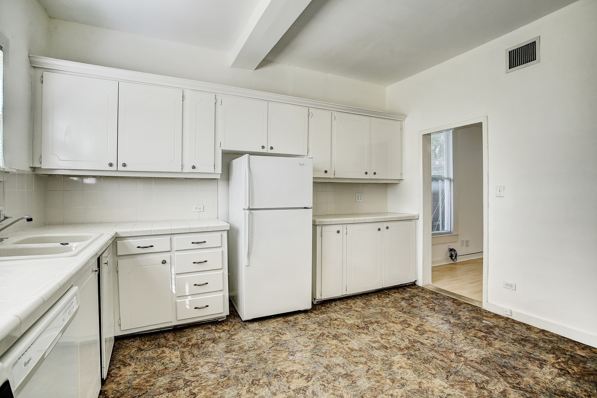 1127 Yale Street, Unit B Houston, TX 77008 - Photo 10 of 14 a kitchen with white cabinets and refrigerator