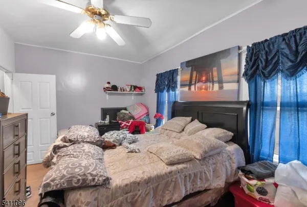 a bedroom with bed and a chandelier