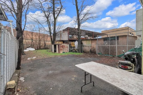 a view of a backyard with plants and trees