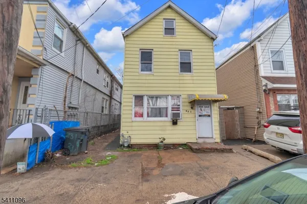 a view of a house with a yard and sitting area