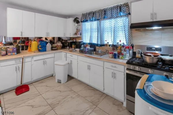 a kitchen with a sink cabinets and window