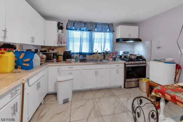 a kitchen with a sink stove and cabinets