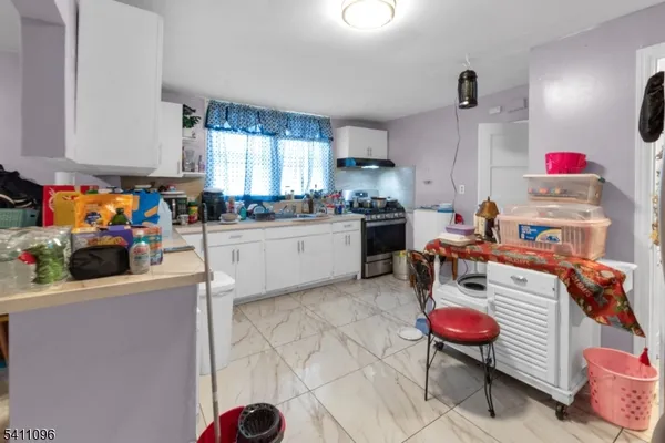 a kitchen with a sink appliances and cabinets
