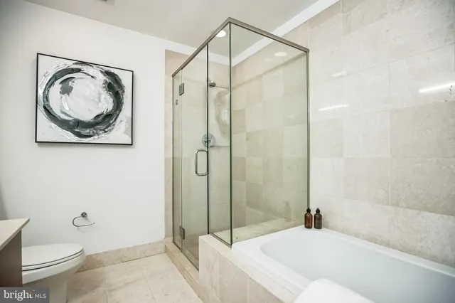 a bathroom with a toilet and a shower