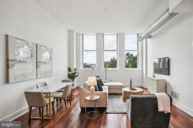 a living room with fireplace furniture and a large window