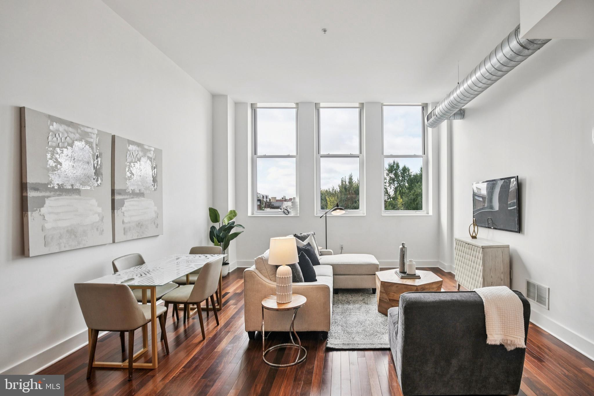 1101 Locust Street, Unit 4E Philadelphia, PA 19107 - Photo 3 of 15 a living room with fireplace furniture and a large window