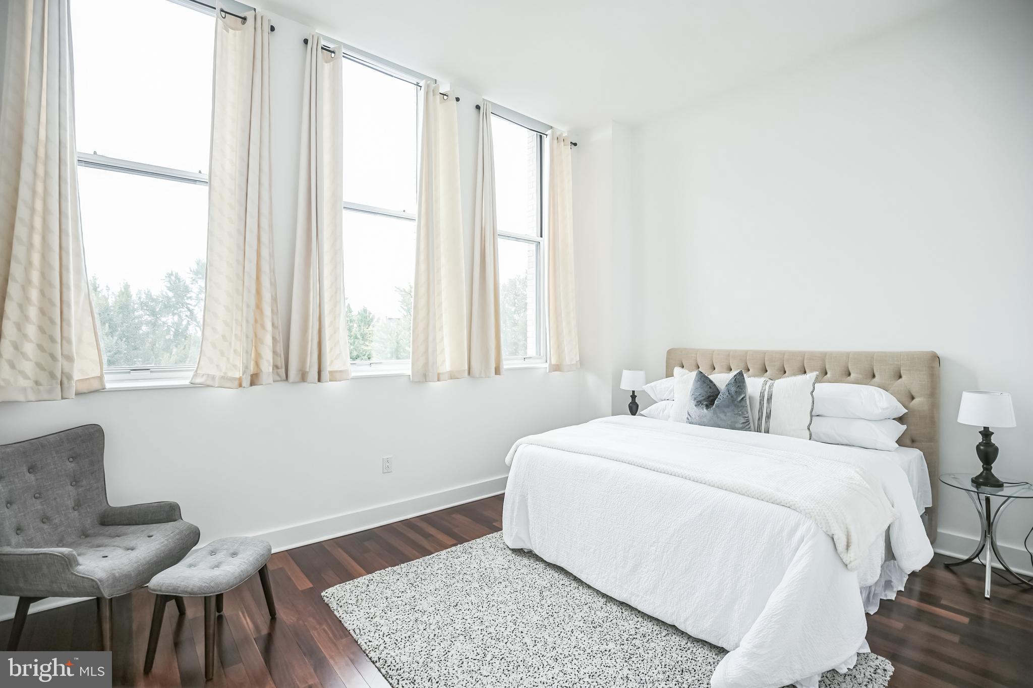 1101 Locust Street, Unit 4E Philadelphia, PA 19107 - Photo 8 of 15 a bedroom with a bed and a window