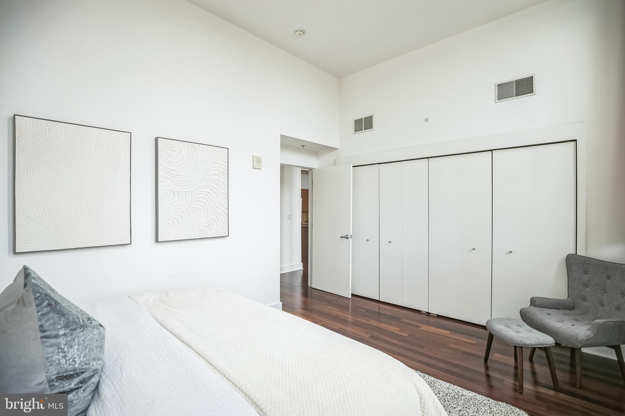 1101 Locust Street, Unit 4E Philadelphia, PA 19107 - Photo 9 of 15 a bedroom with a bed and a chair