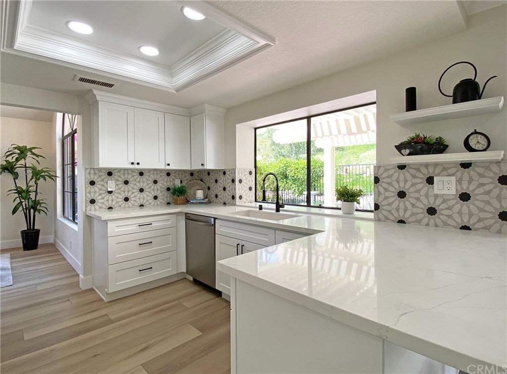 a kitchen with granite countertop a window and white appliances
