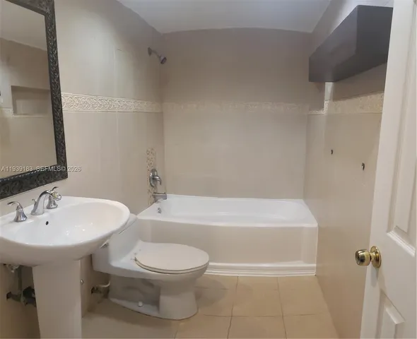 an empty room with windows and ceiling fan