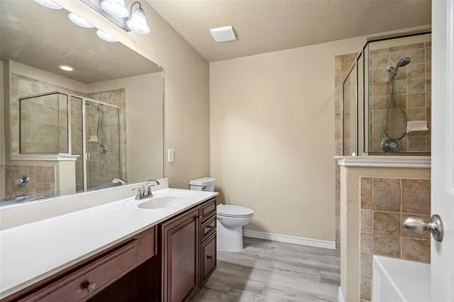 a bathroom with a double vanity sink toilet and shower