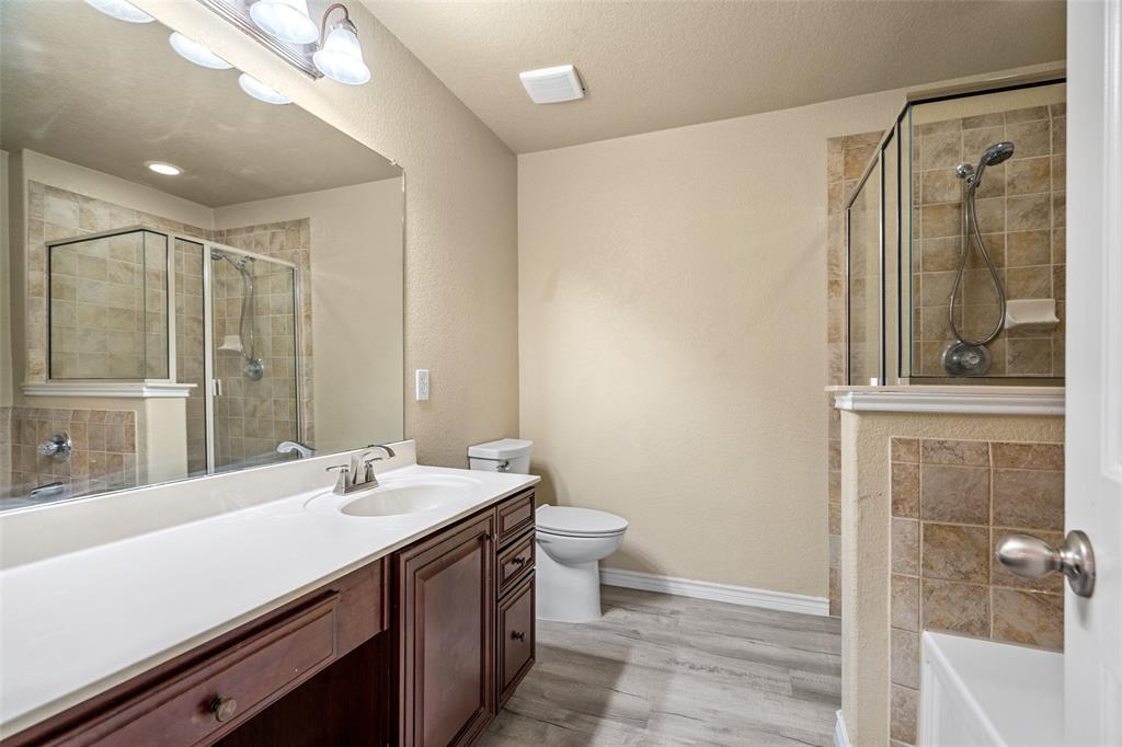 4024 Mantis Street Fort Worth, TX 76106 - Photo 12 of 27 a bathroom with a double vanity sink toilet and shower