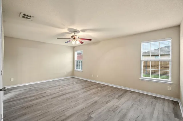 wooden floor in an empty room with a window