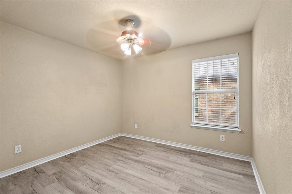 4024 Mantis Street Fort Worth, TX 76106 - Photo 19 of 27 a view of an empty room with a chandelier fan and a window