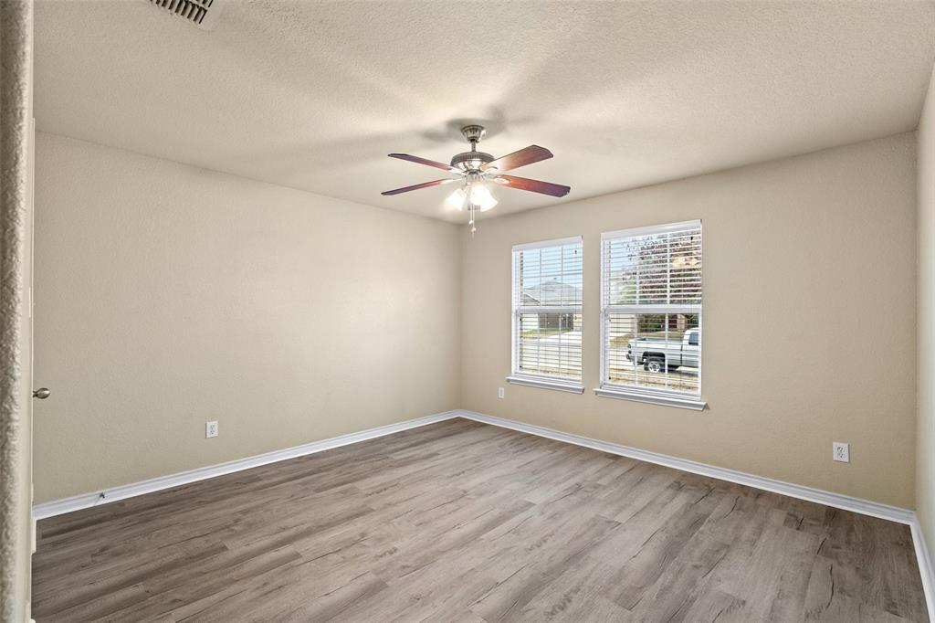 4024 Mantis Street Fort Worth, TX 76106 - Photo 20 of 27 an empty room with wooden floor and windows