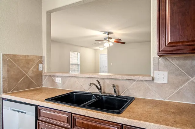 a kitchen with a sink and cabinets