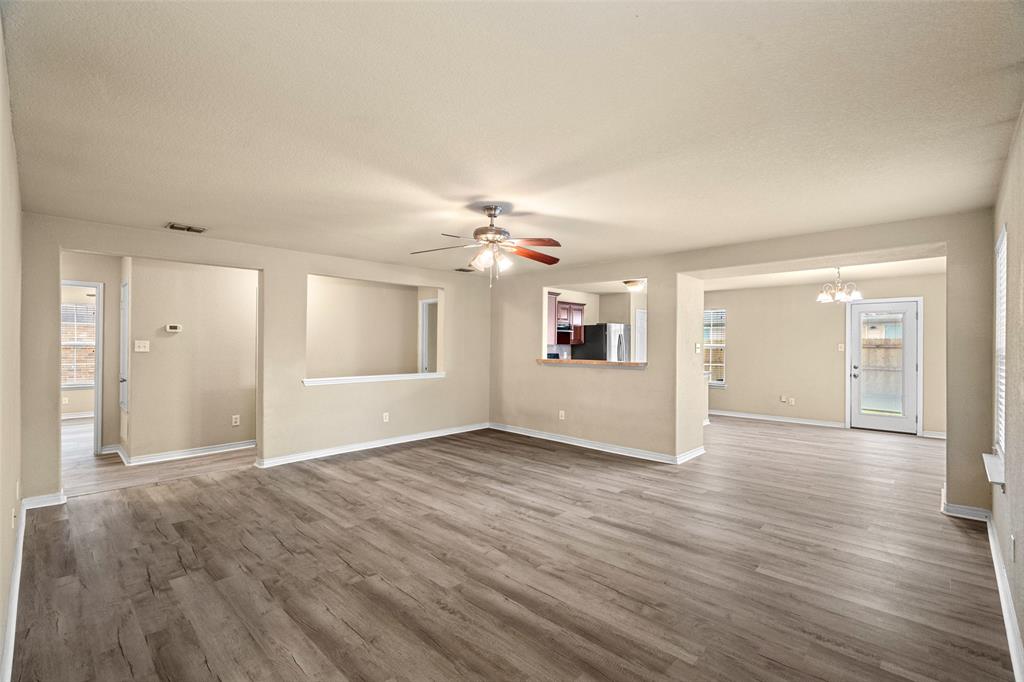 4024 Mantis Street Fort Worth, TX 76106 - Photo 7 of 27 a view of an empty room with window and wooden floor