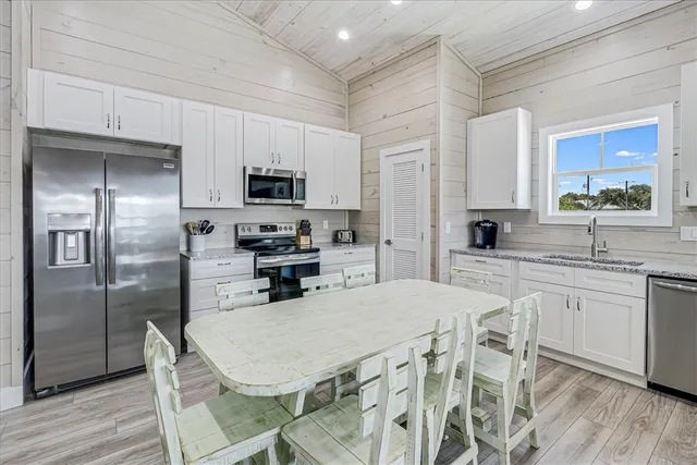 a kitchen with stainless steel appliances a refrigerator sink and cabinets