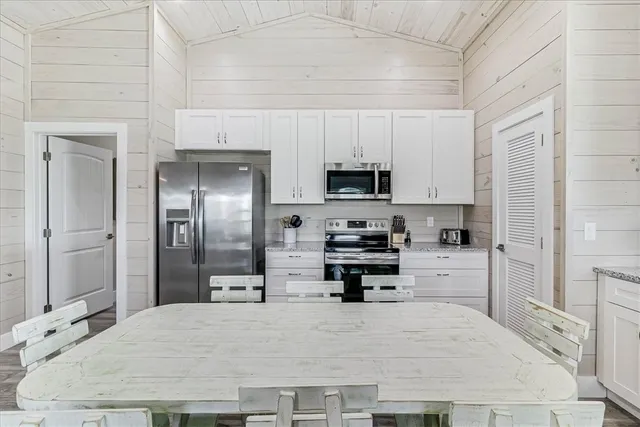 a kitchen with stainless steel appliances a refrigerator sink and microwave
