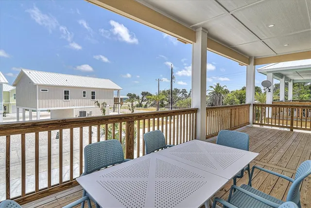 a view of a balcony with wooden floor