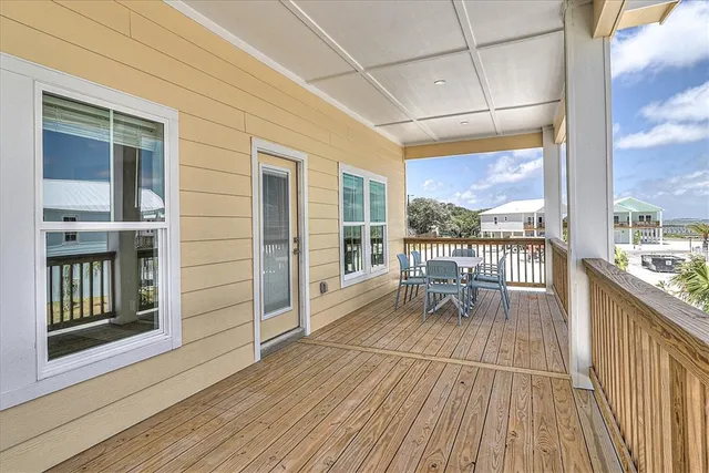 a view of a balcony with wooden floor