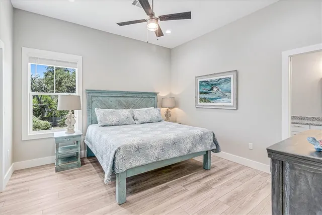 a bedroom with a bed lamp and a window