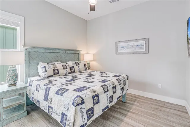 a bedroom with bed and a night stand