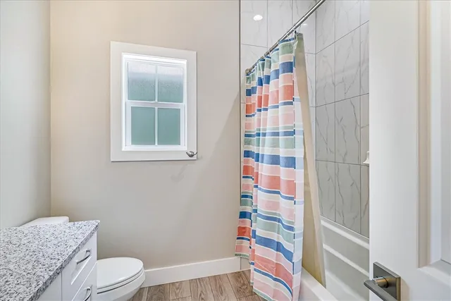 a bathroom with a sink toilet and shower